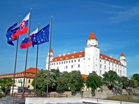 The EU flag waving in front of the Bratislava Castle.